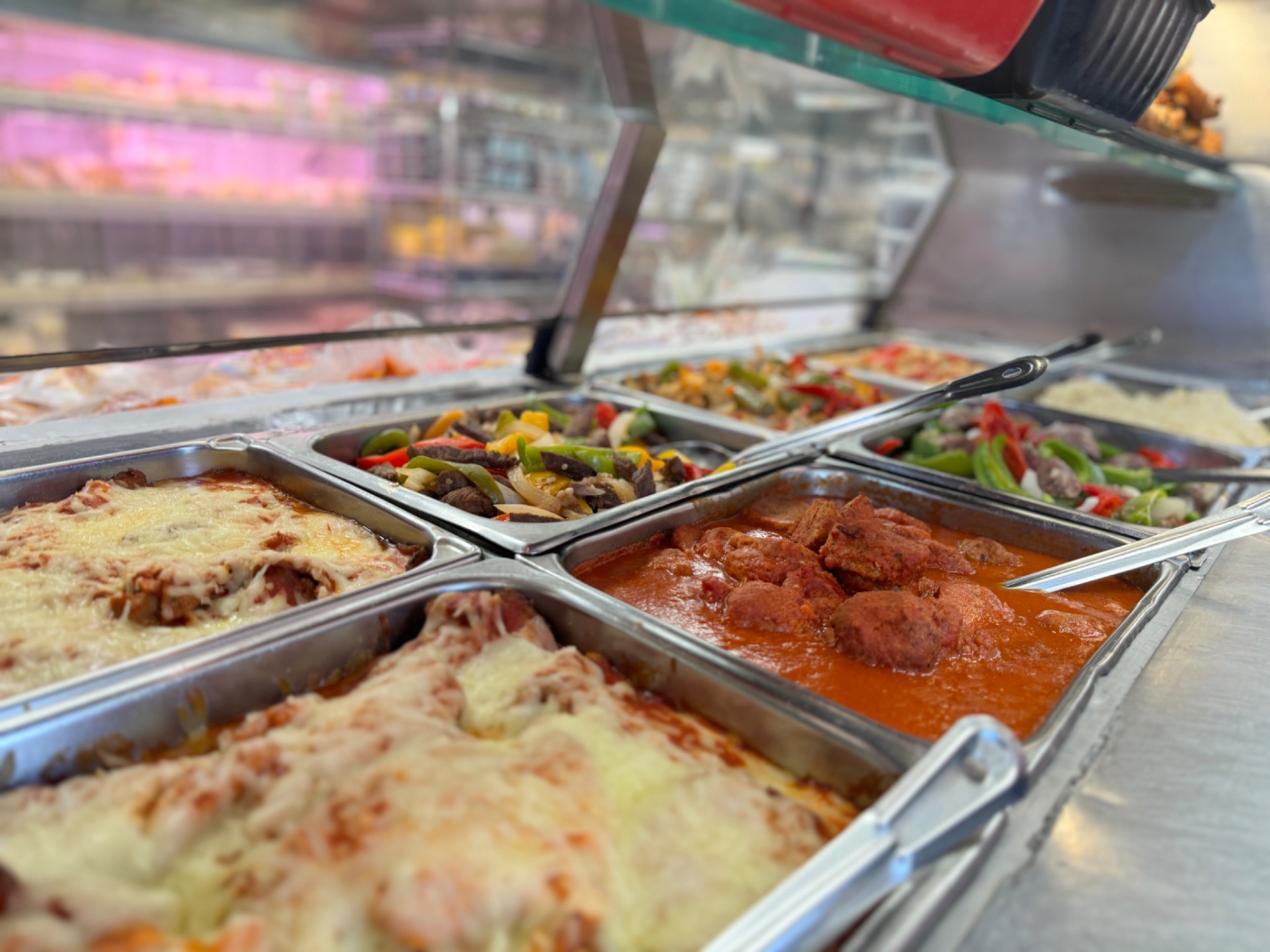 Hot food case with eggplant parm, meatballs and sausage & peppers