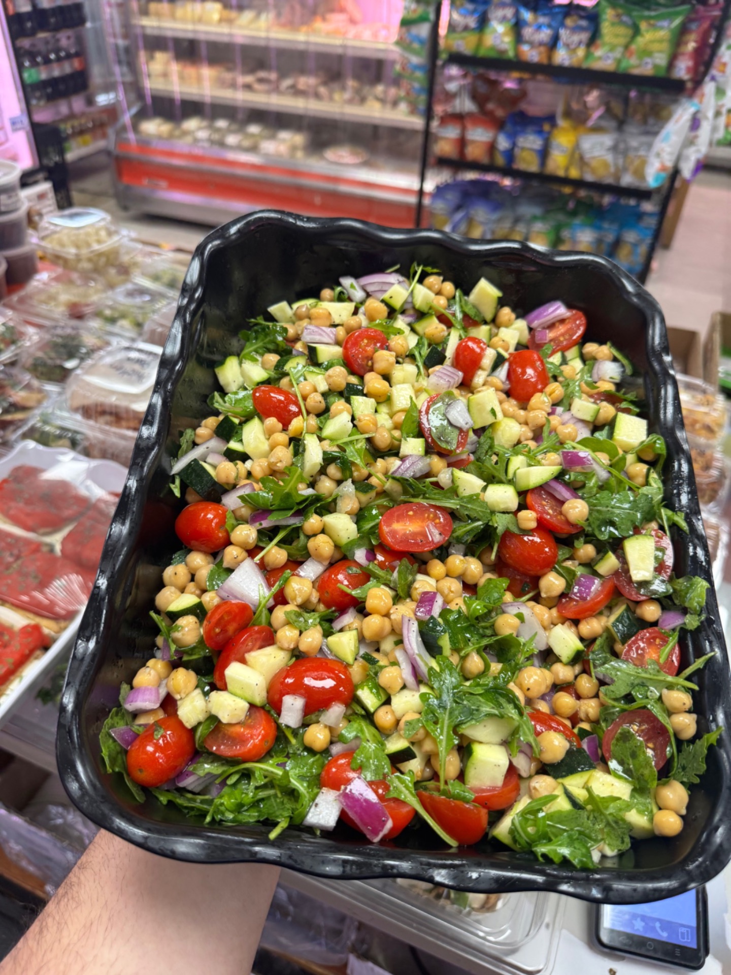 Chickpea salad with arugula, cherry tomatoes, zucchini and red onion